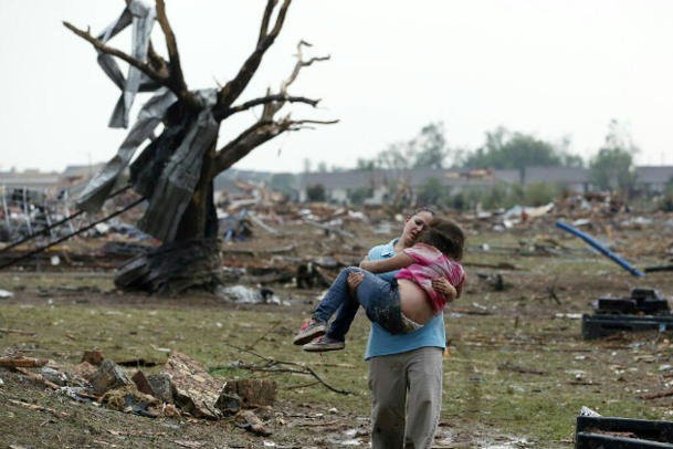woman carries child in Moore Oklahoma